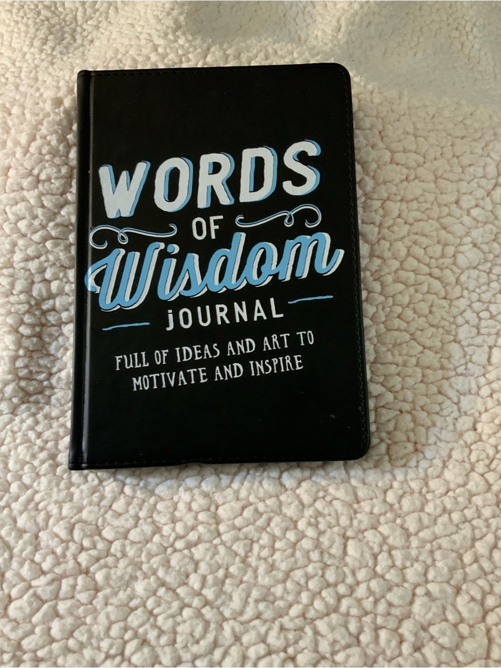 Source Unknown Black Journal with White and Light Blue Typography